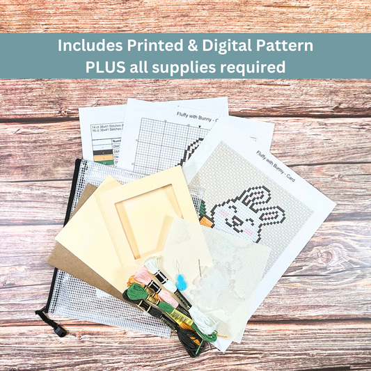 Complete cross-stitch kit including Aida cloth, embroidery floss, pattern sheets, and greeting card materials.
