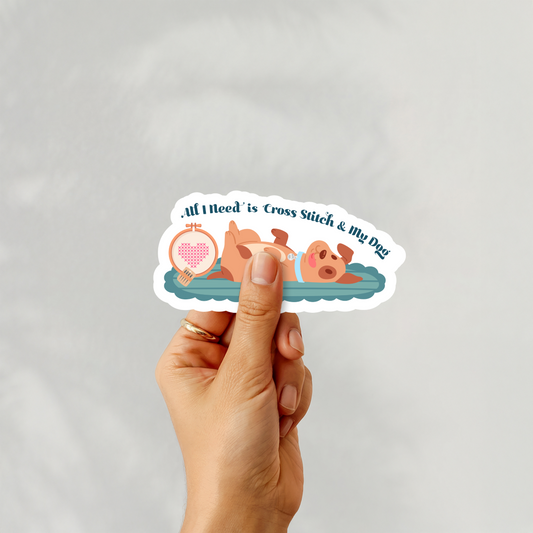 Handheld sticker of “All I Need is Cross Stitch & My Dog”