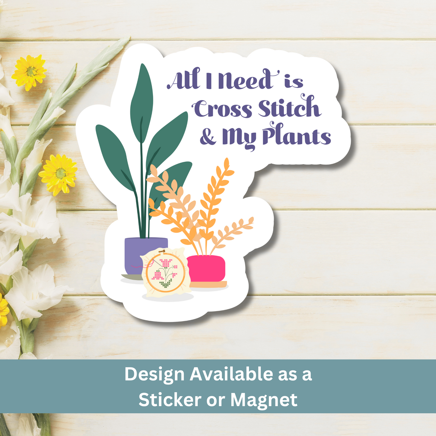 Flat lay of cross-stitch and plant-themed magnet on rustic wood background