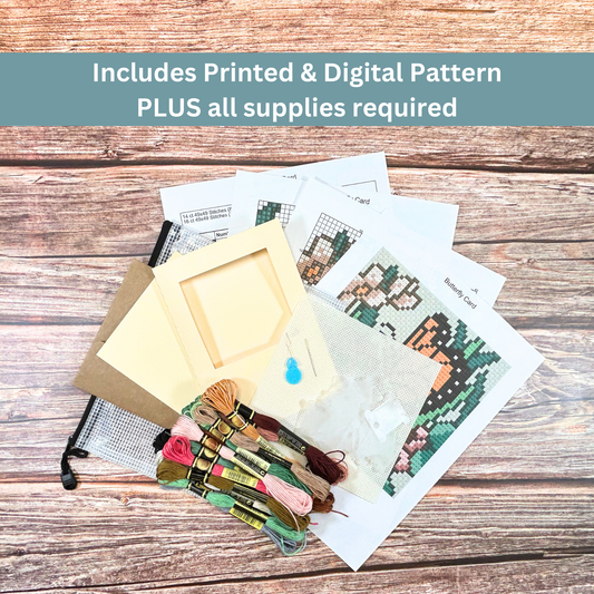 Complete cross-stitch kit including Aida cloth, embroidery floss, pattern sheets, and greeting card materials.