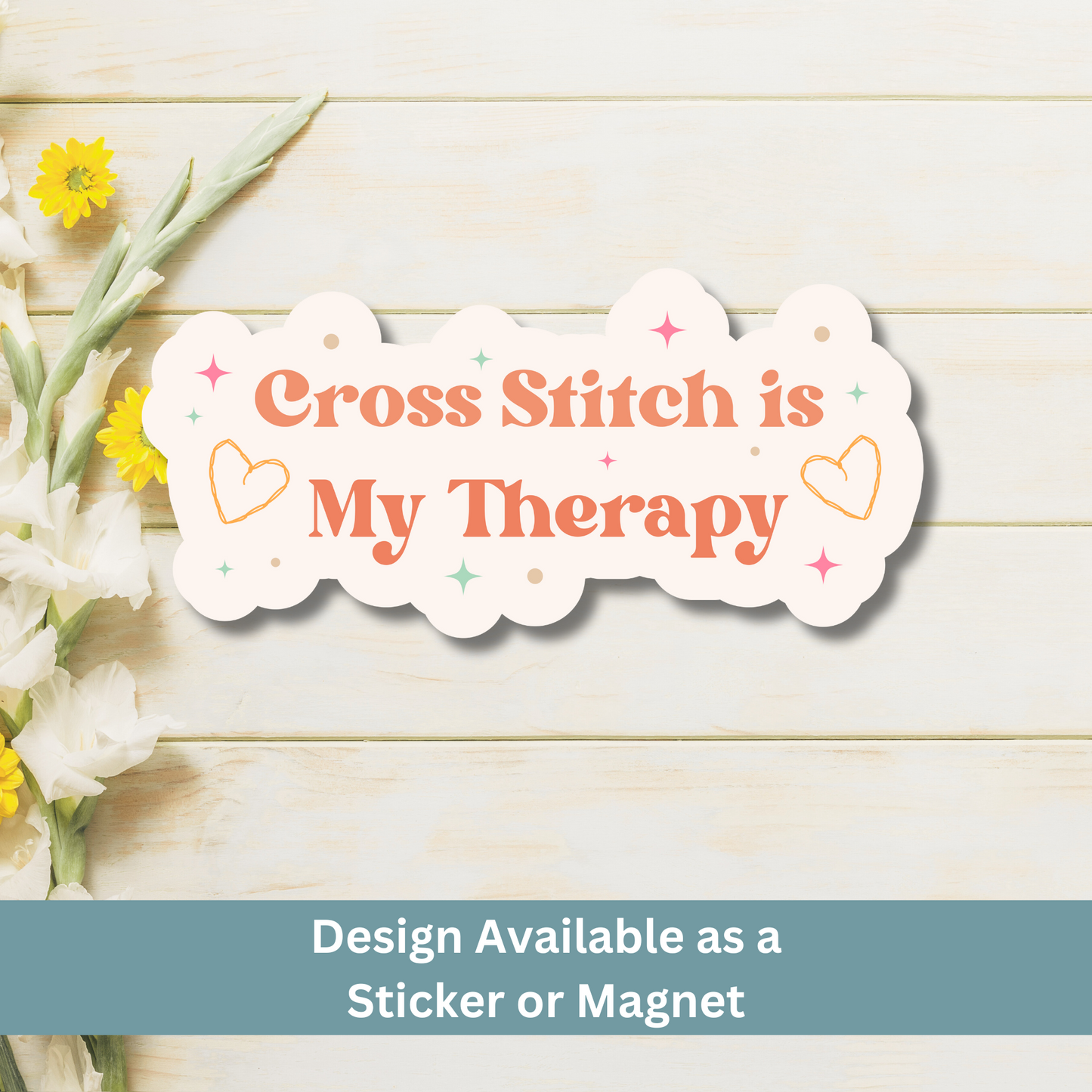 Flat lay image of calming cross-stitch quote magnet on wood plank background