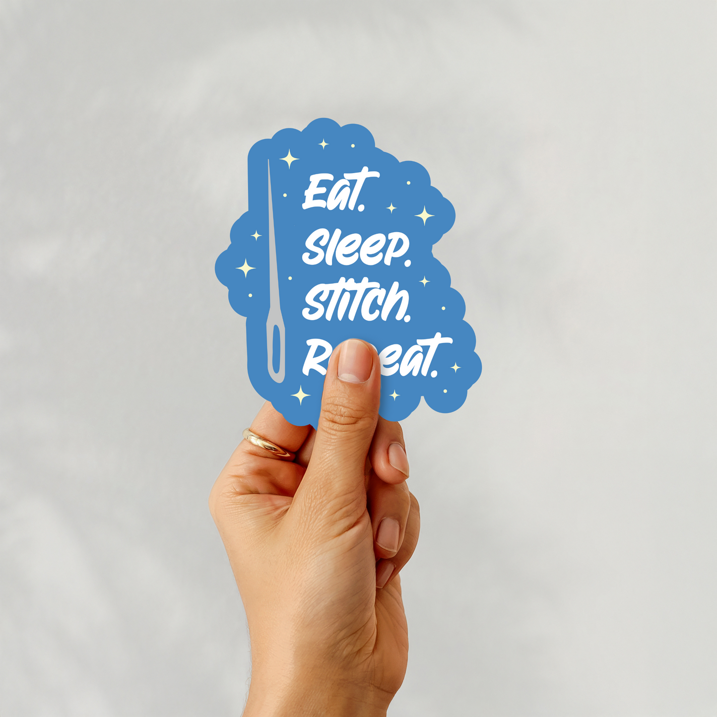 Handheld sticker of “Eat. Sleep. Stitch. Repeat.” design