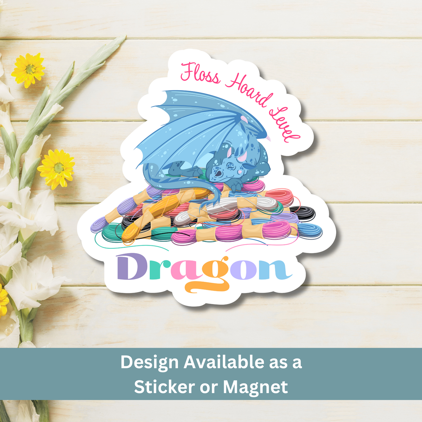 Wood Flat Lay Magnet: A magnet of a dragon sitting on embroidery floss on a wooden surface, text says "Floss Hoard Level Dragon"