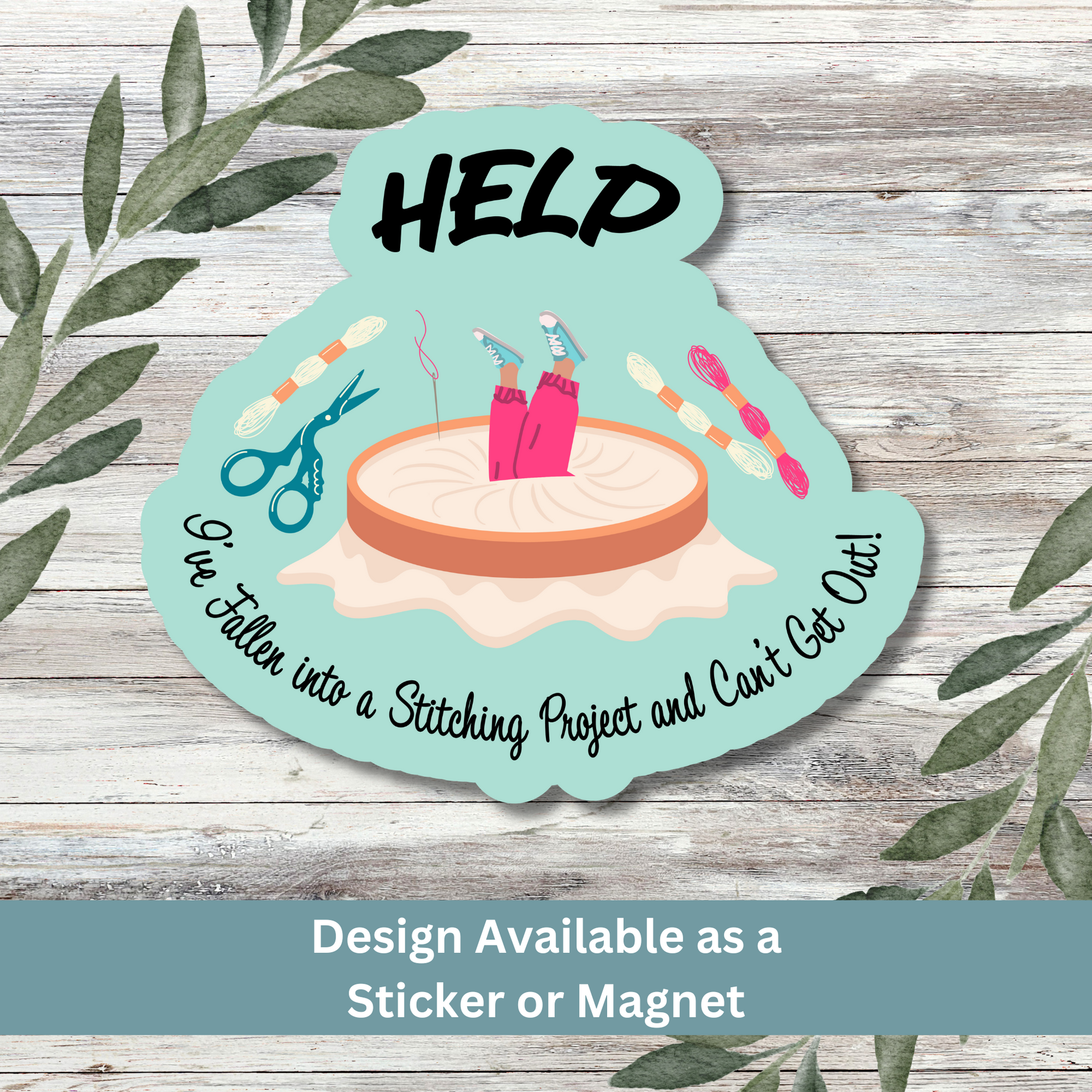 Funny cross-stitch sticker reading “Help I’ve Fallen…” on whitewashed plank background