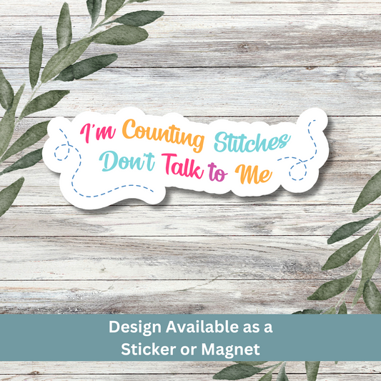 Sticker of “I’m Counting Stitches Don’t Talk to Me” on a whitewashed wood background