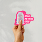 Hand holding ‘Show Me Your ORTs!’ sticker with jar of thread snippets and playful text