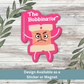 ‘The Bobbinator’ sticker displayed on whitewashed wood background with bold pink design