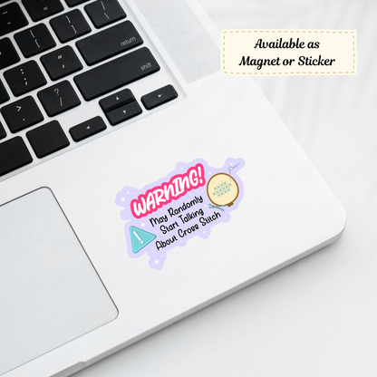 A cheeky warning sticker on a laptop lid, featuring embroidery elements