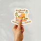 Hand holding a cozy chair and lamp sticker labeled “Weekend Plans: Stitching & More Stitching”